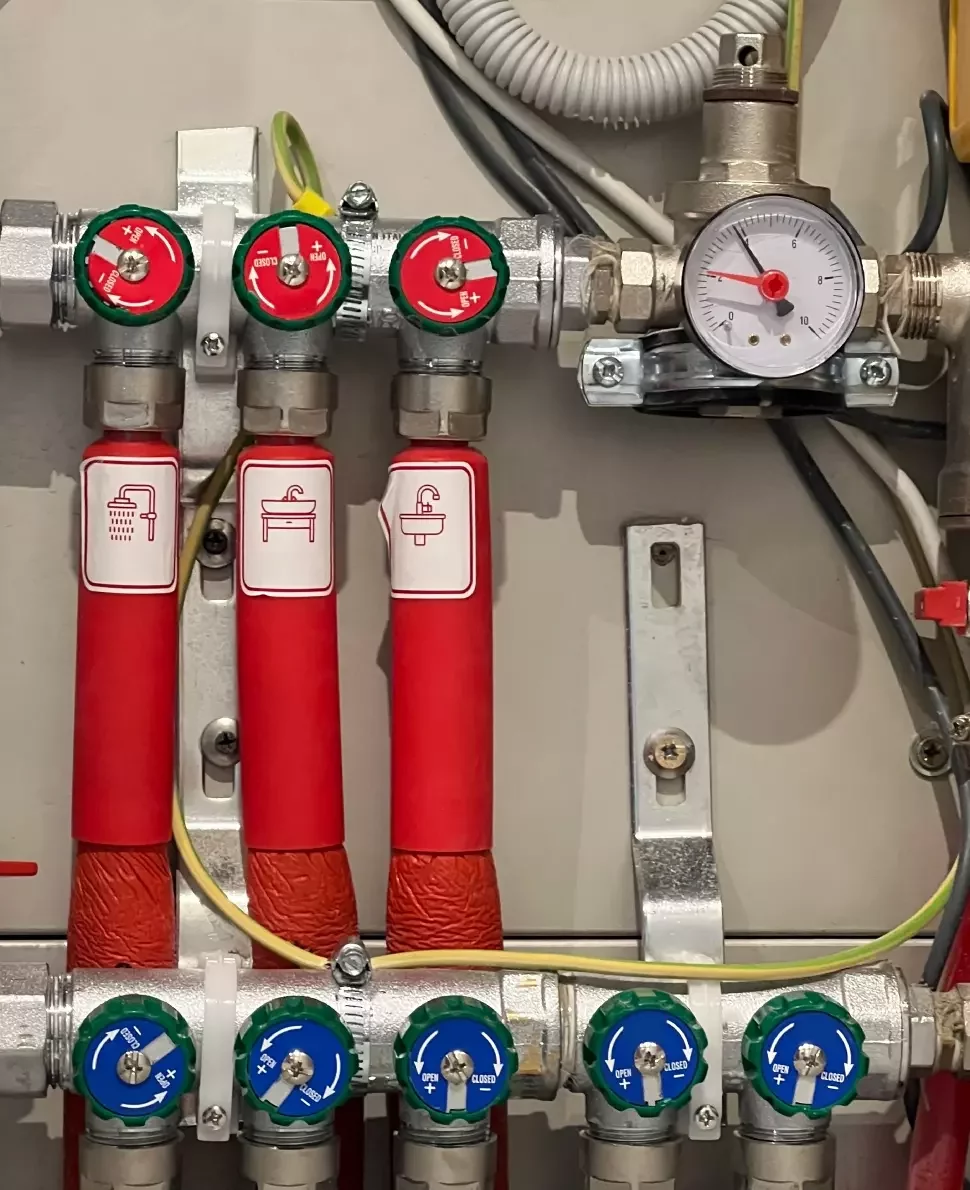 Gas boiler valves for sink and shower.